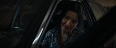 a woman sitting in the passenger seat of a car