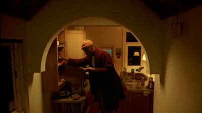 a man standing in a doorway of a kitchen