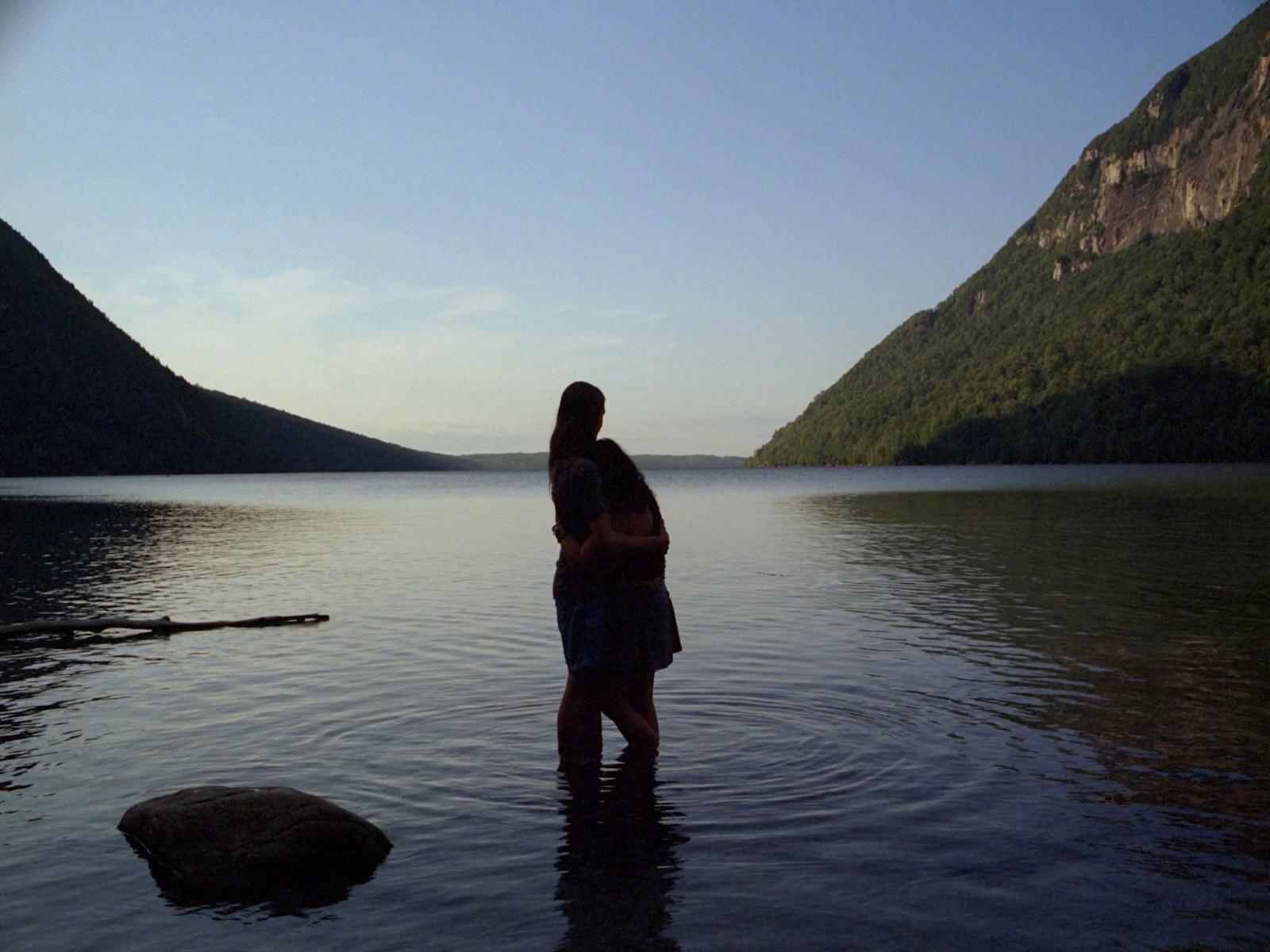 a man and a woman standing in a body of water