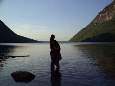 a man and a woman standing in a body of water