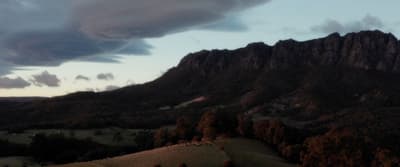 a view of a mountain with clouds in the sky