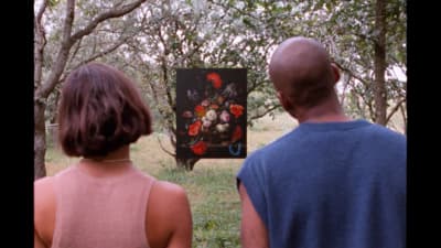 a man and a woman looking at a painting