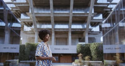 a woman standing in front of a tall building
