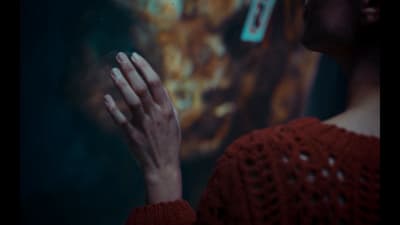 a woman in a red sweater holding her hands together