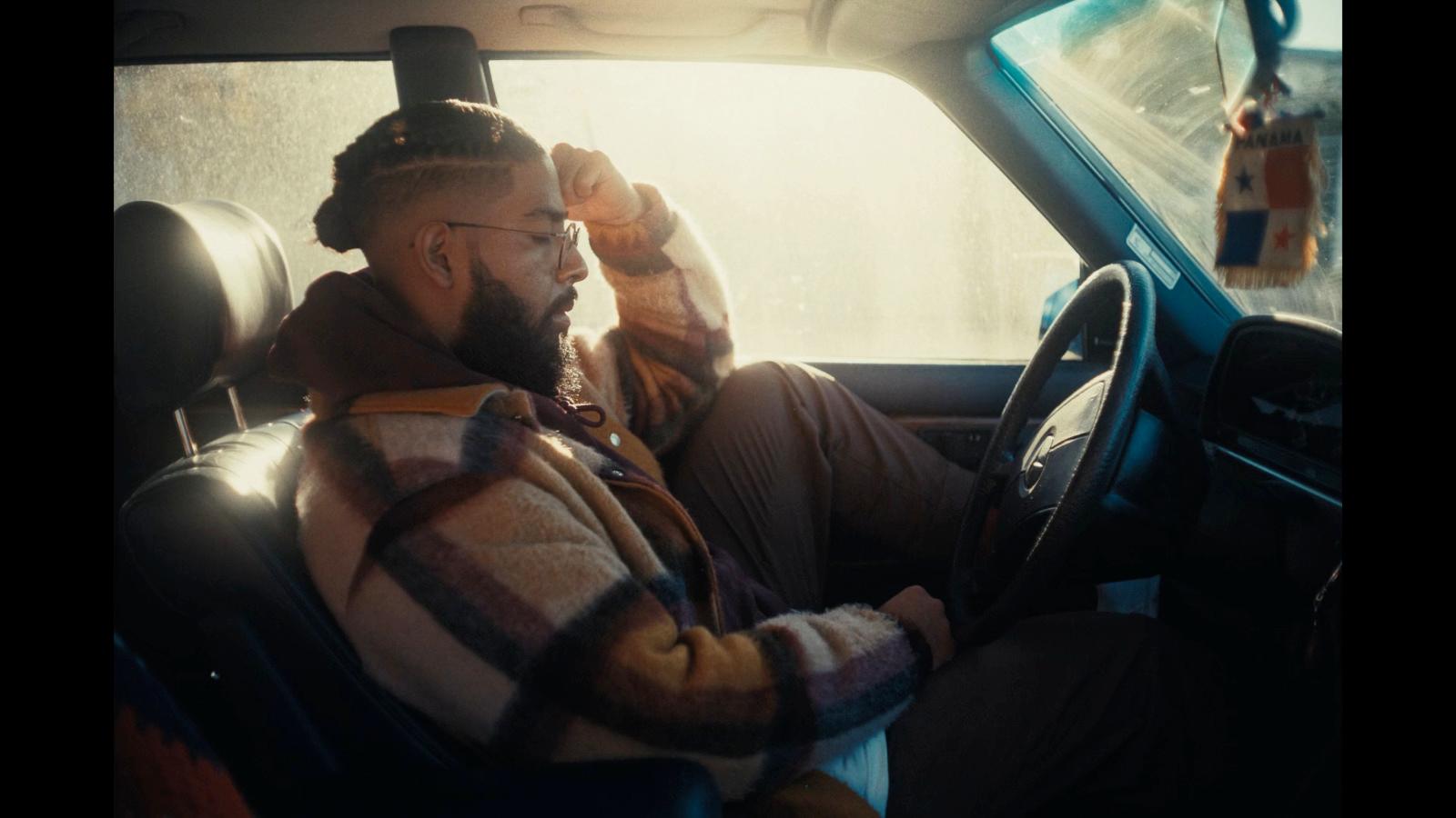 a man sitting in the driver's seat of a car
