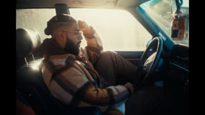 a man sitting in the driver's seat of a car