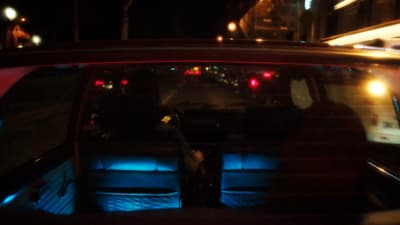 a view of a city street at night from inside a car
