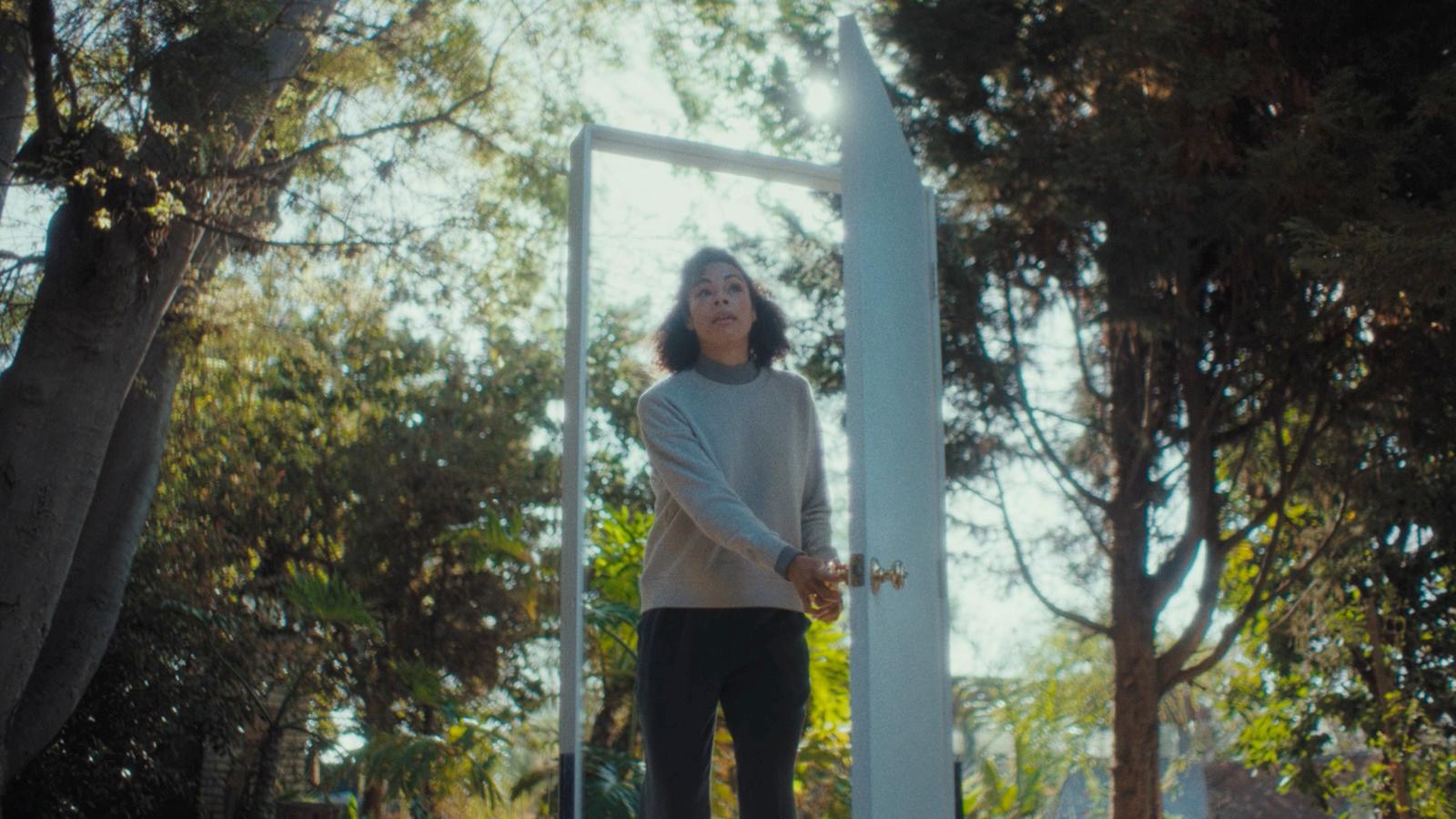 a woman standing in front of a mirror in a park