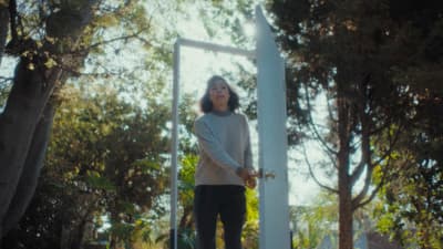 a woman standing in front of a mirror in a park