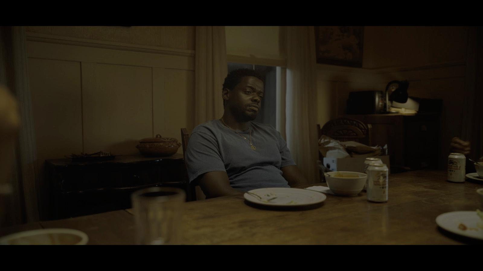 a man sitting at a table with a plate of food