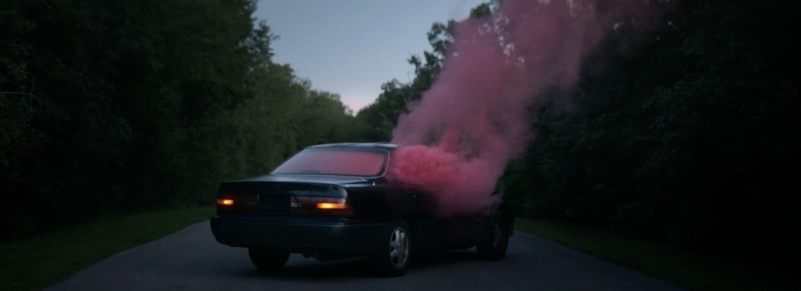a car with pink smoke coming out of it
