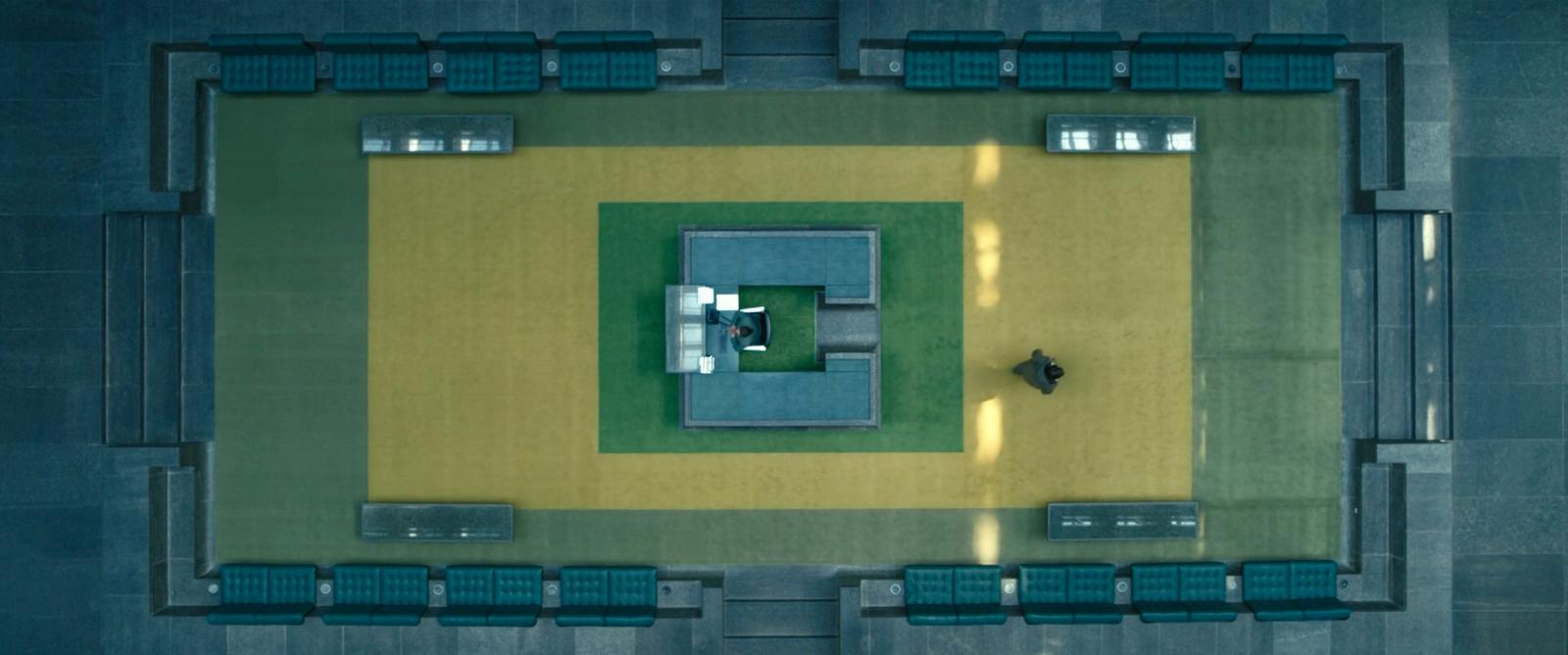 an aerial view of a building with benches