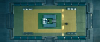 an aerial view of a building with benches