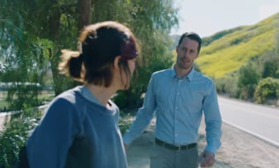 a man and a woman walking down a road