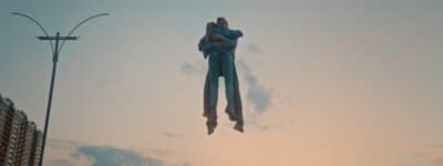 a couple of people are floating in the air