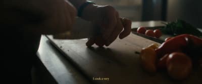 a person cutting tomatoes on a cutting board