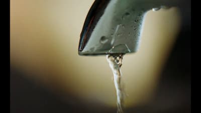 a close up of a faucet with water coming out of it