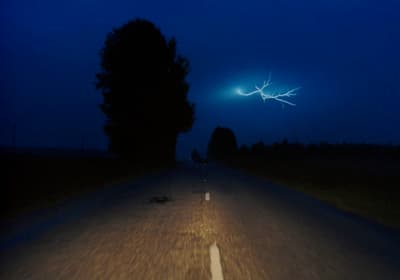 a car driving down a road at night