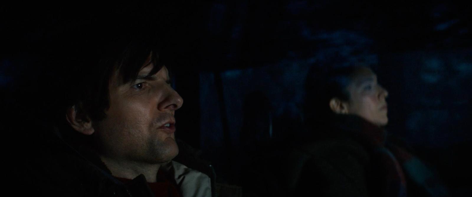 a man and a woman in a dark room