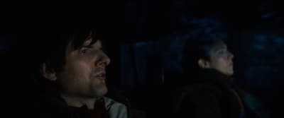 a man and a woman in a dark room