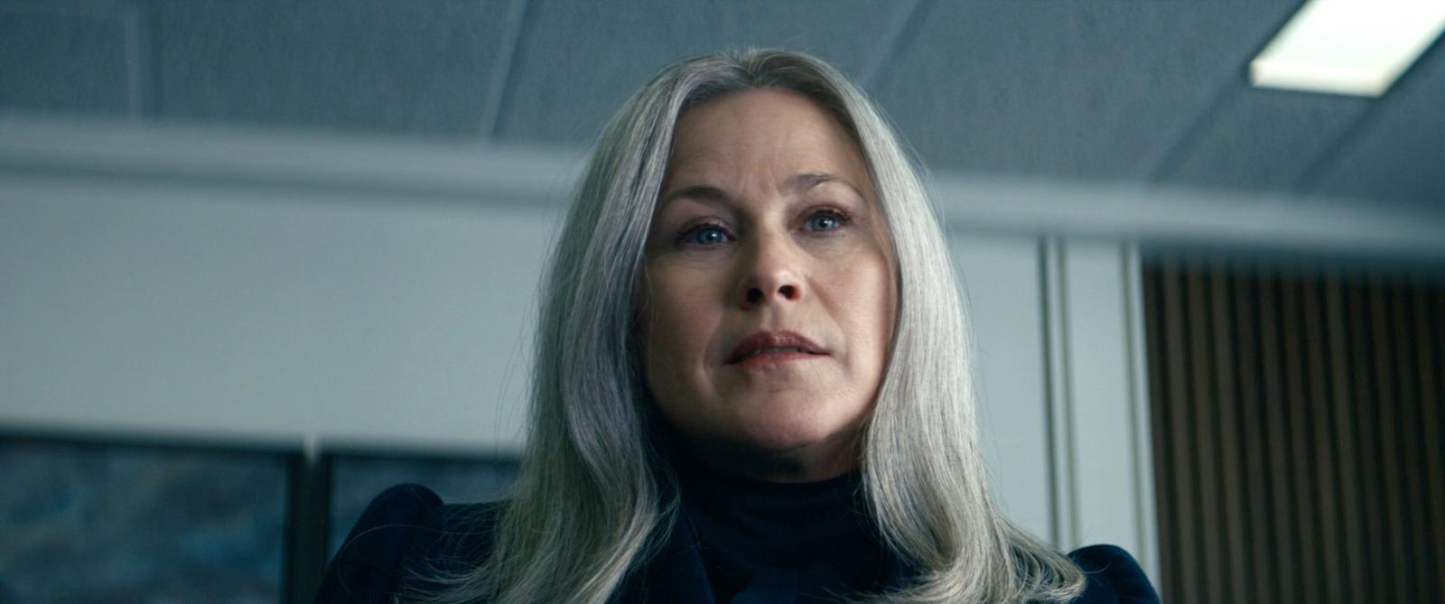 a woman with blonde hair looking off into the distance