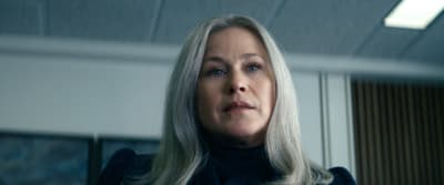 a woman with blonde hair looking off into the distance