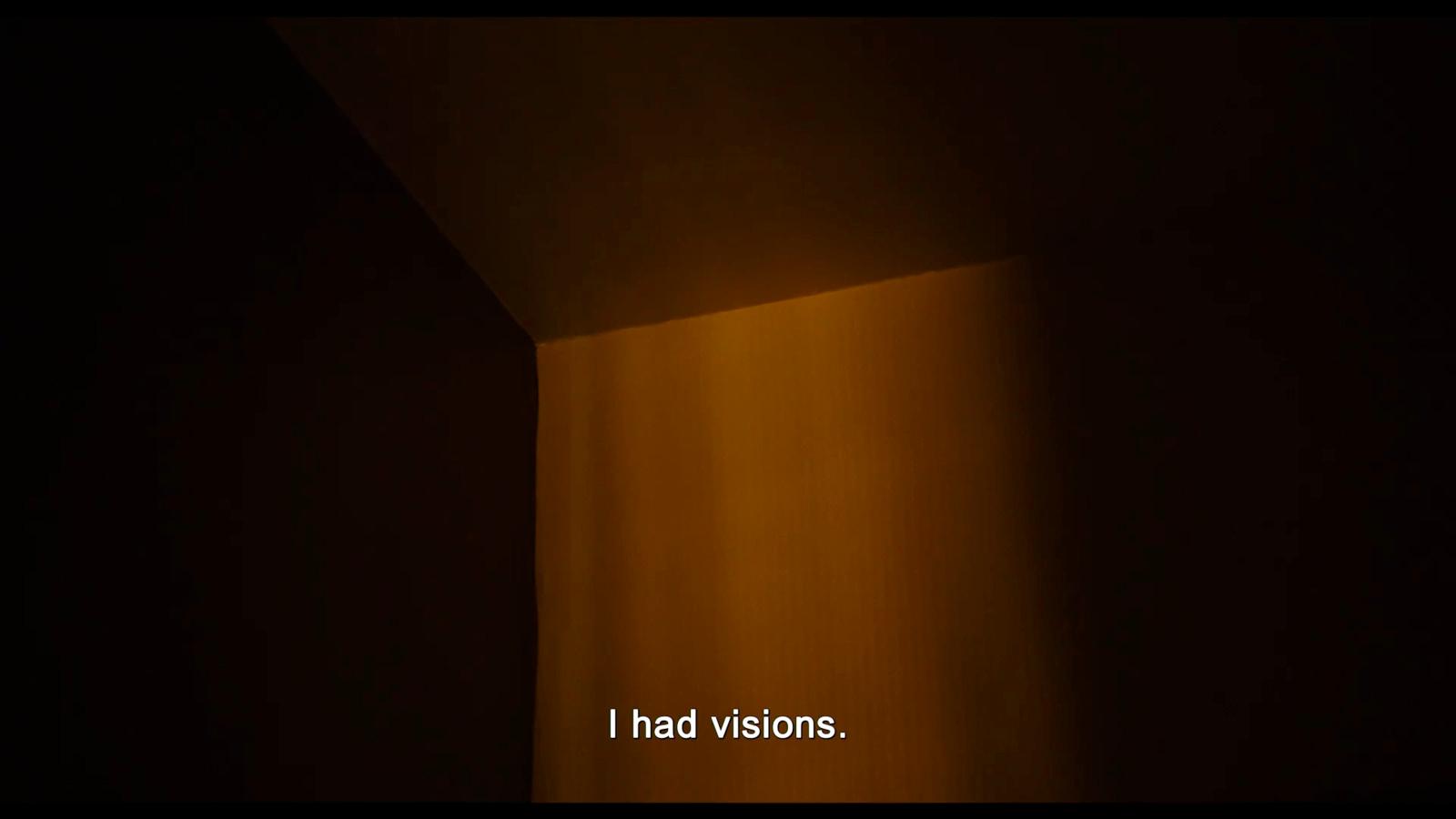 a dark room with a light coming from the ceiling
