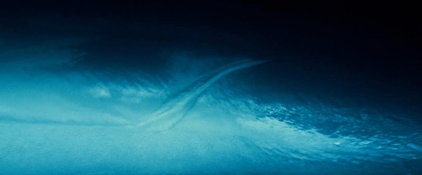 a man riding a surfboard on a wave in the ocean