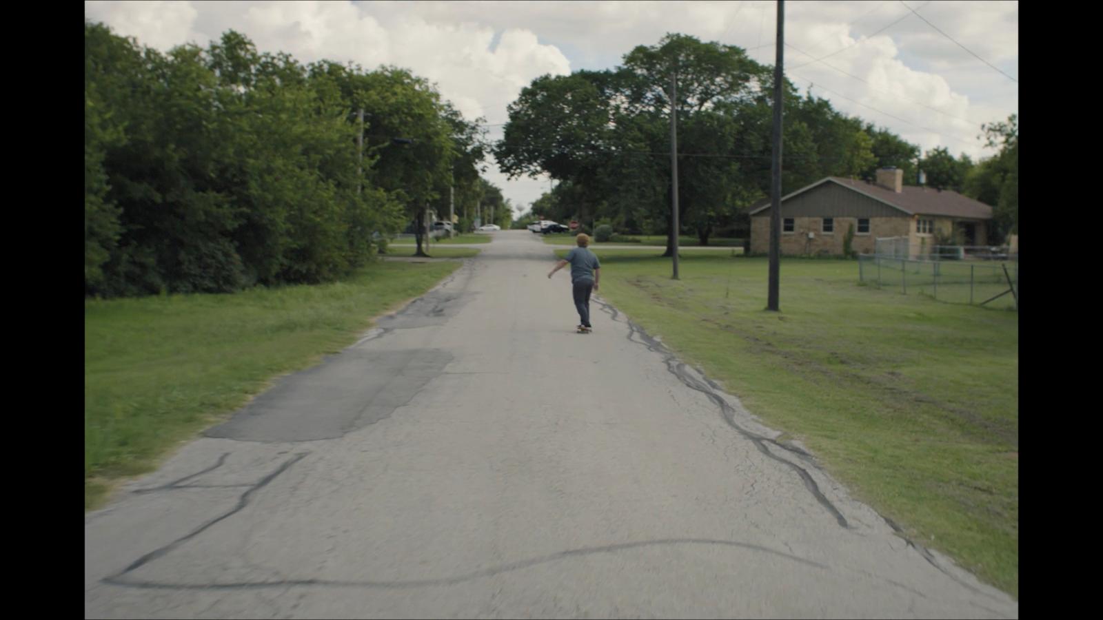 a person riding a skateboard down a street