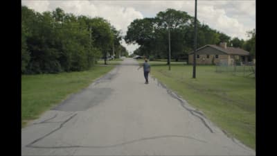a person riding a skateboard down a street