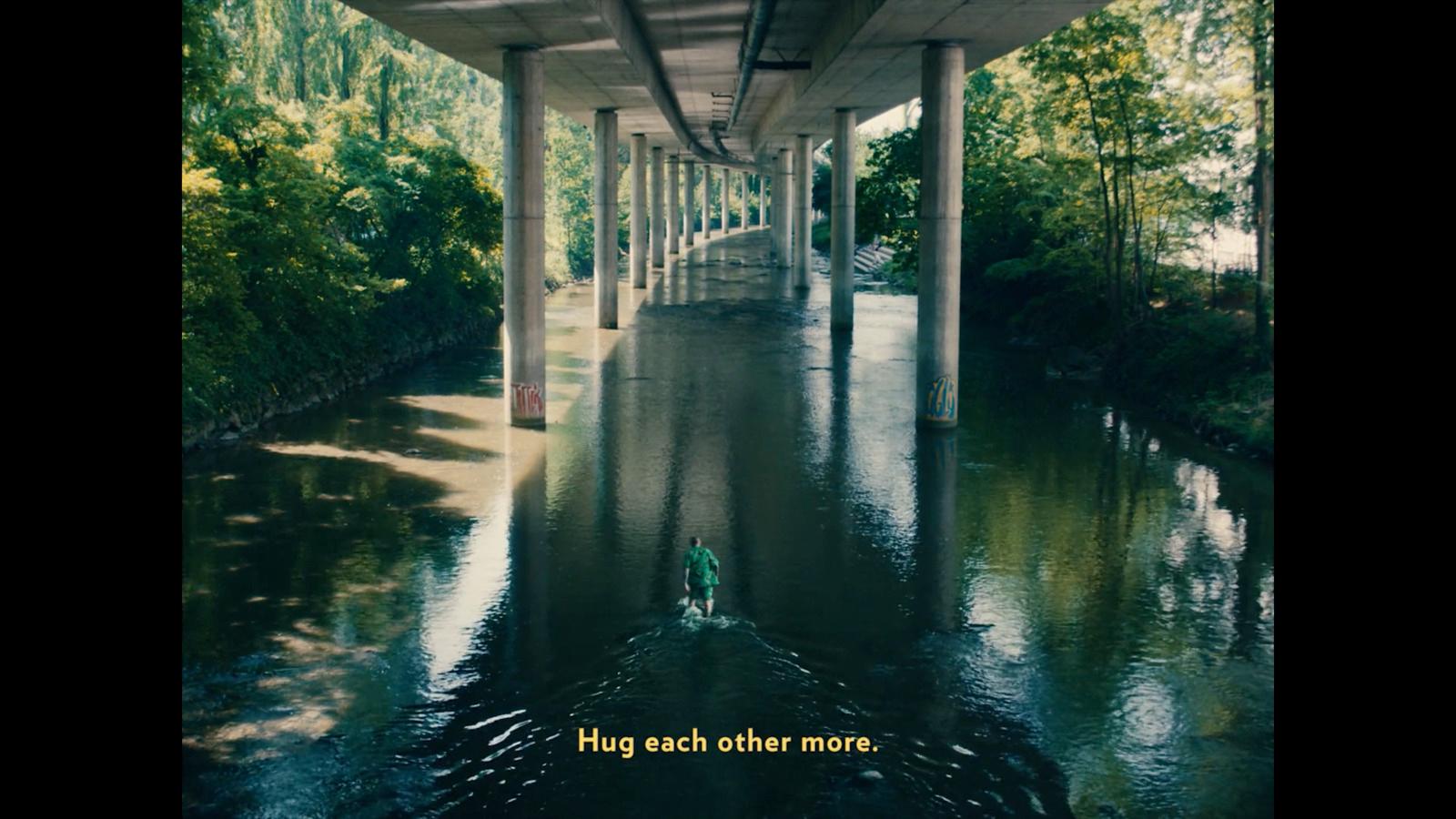 a bridge over a river with a person in a boat under it