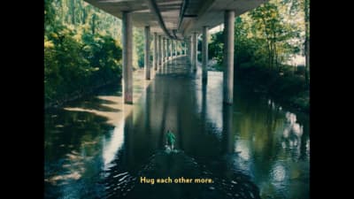 a bridge over a river with a person in a boat under it