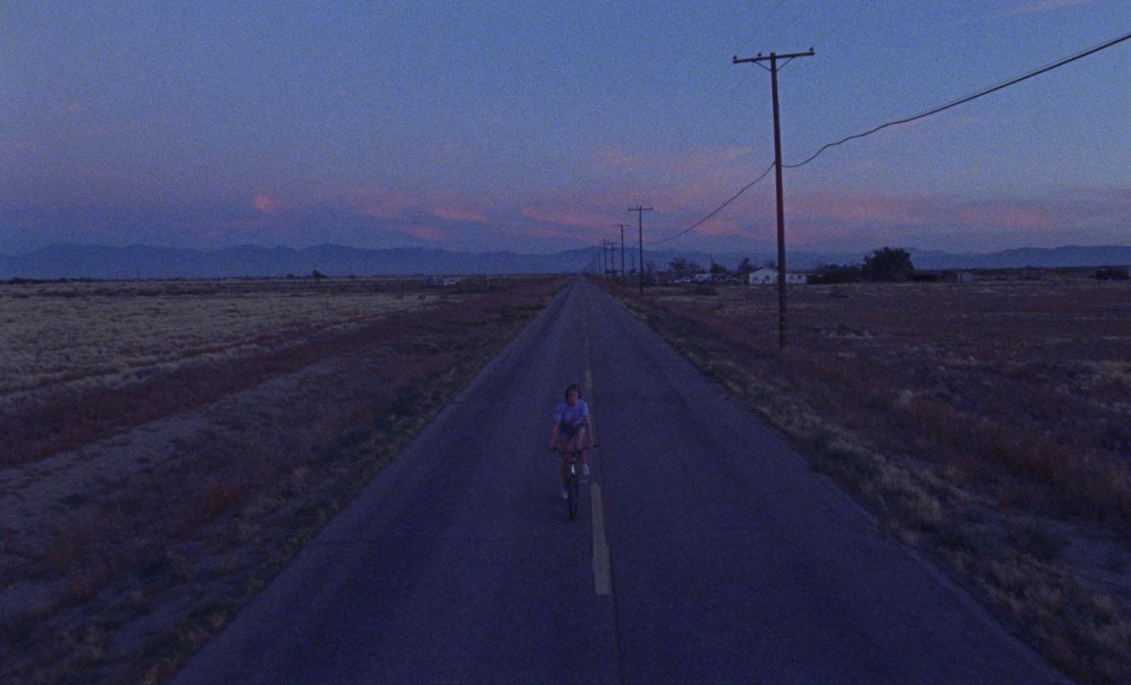 a person riding a bike down a road