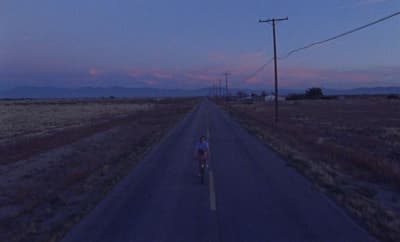 a person riding a bike down a road