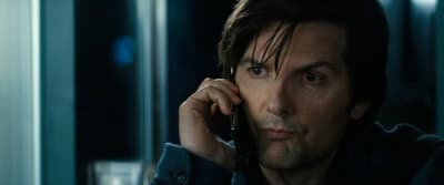 a man talking on a cell phone in a room