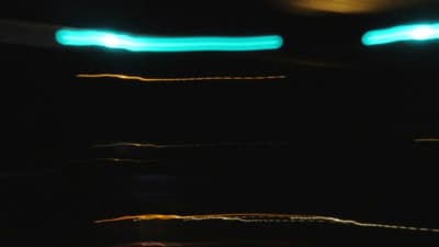 a blurry photo of a street light in the dark