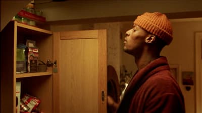 a man in a red sweater and a brown hat