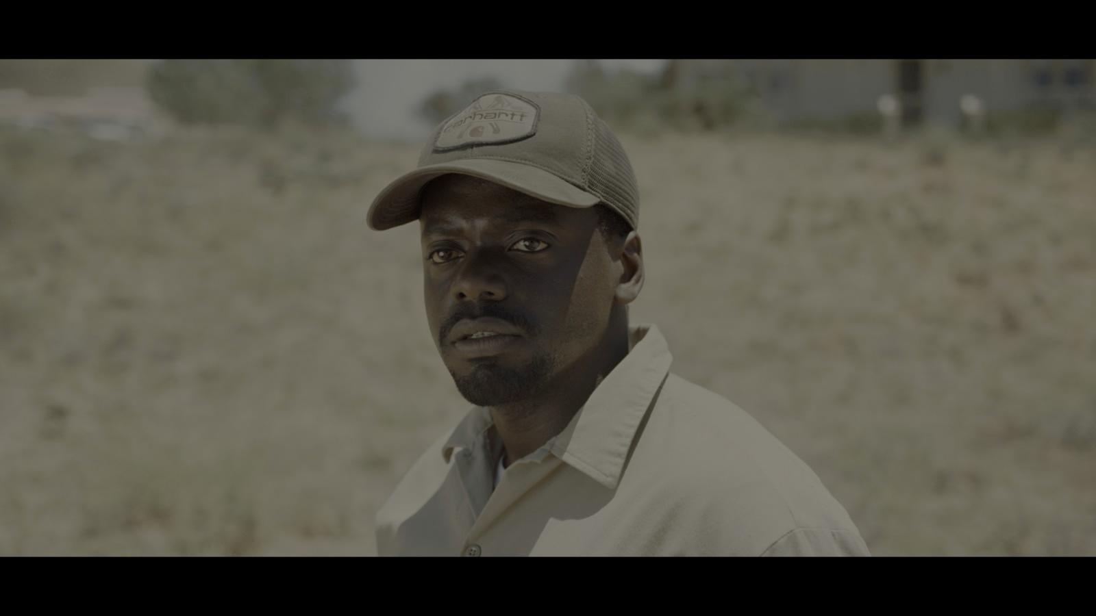 a man wearing a hat in a field