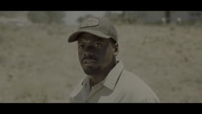 a man wearing a hat in a field