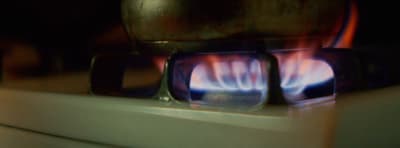 a close up of a stove with a blue flame