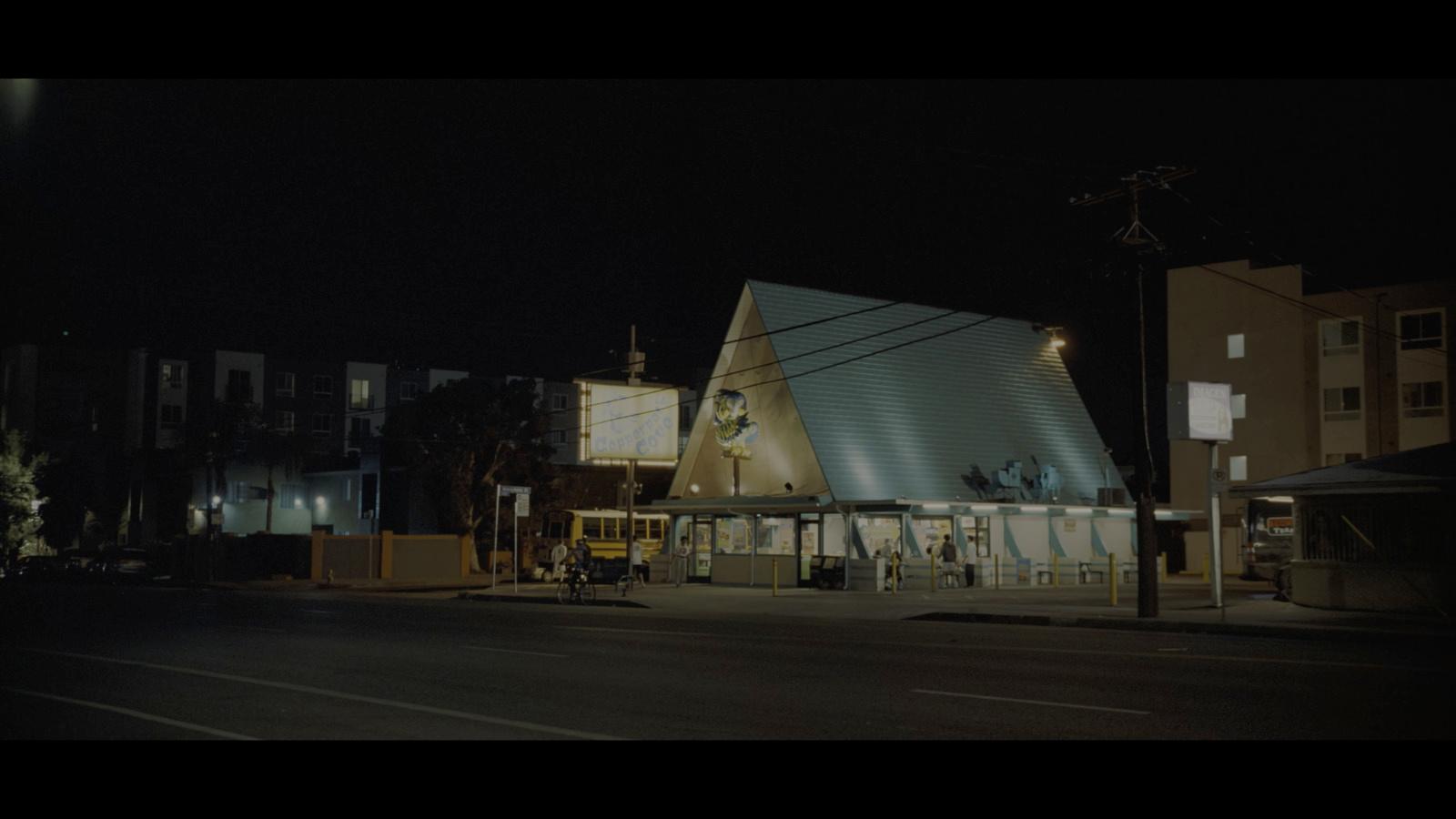 a building with a large triangular roof at night