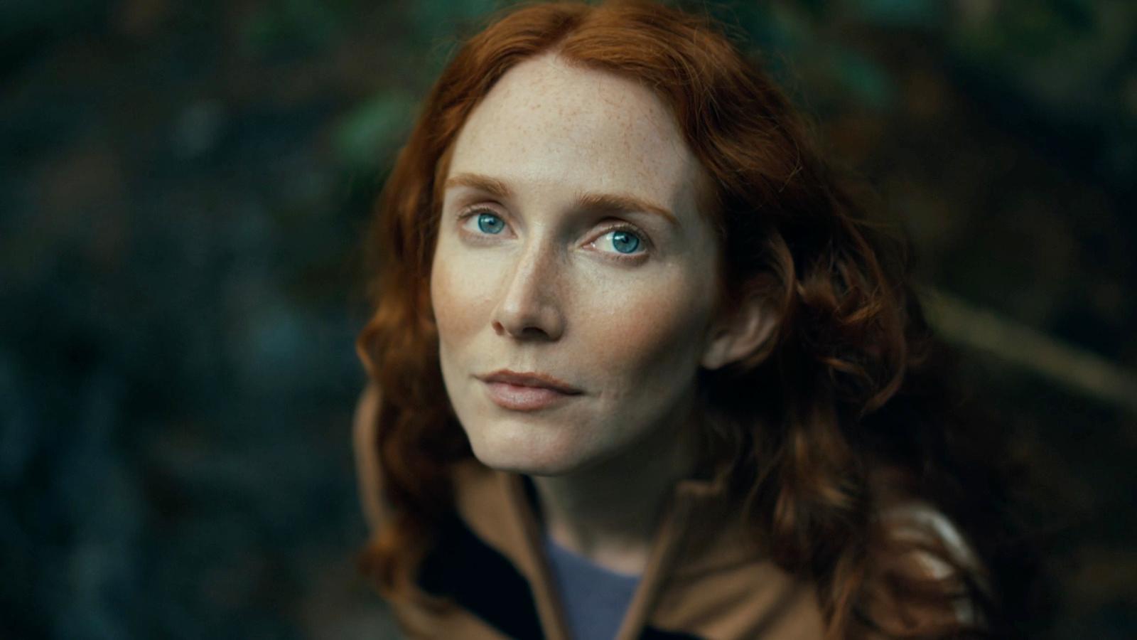 a close up of a person with red hair
