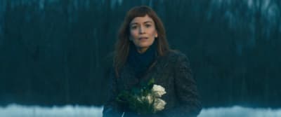 a woman holding a bouquet of flowers in her hands