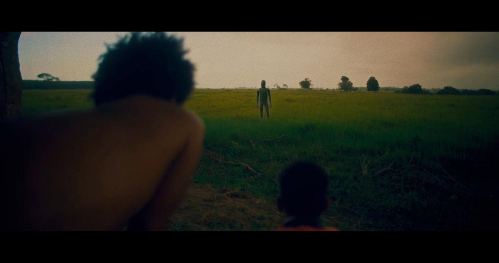 a man and a woman standing in a field