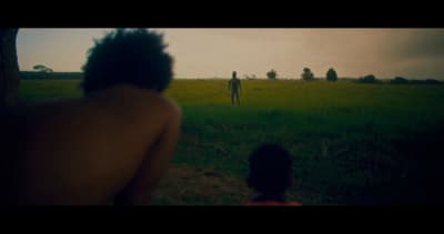 a man and a woman standing in a field