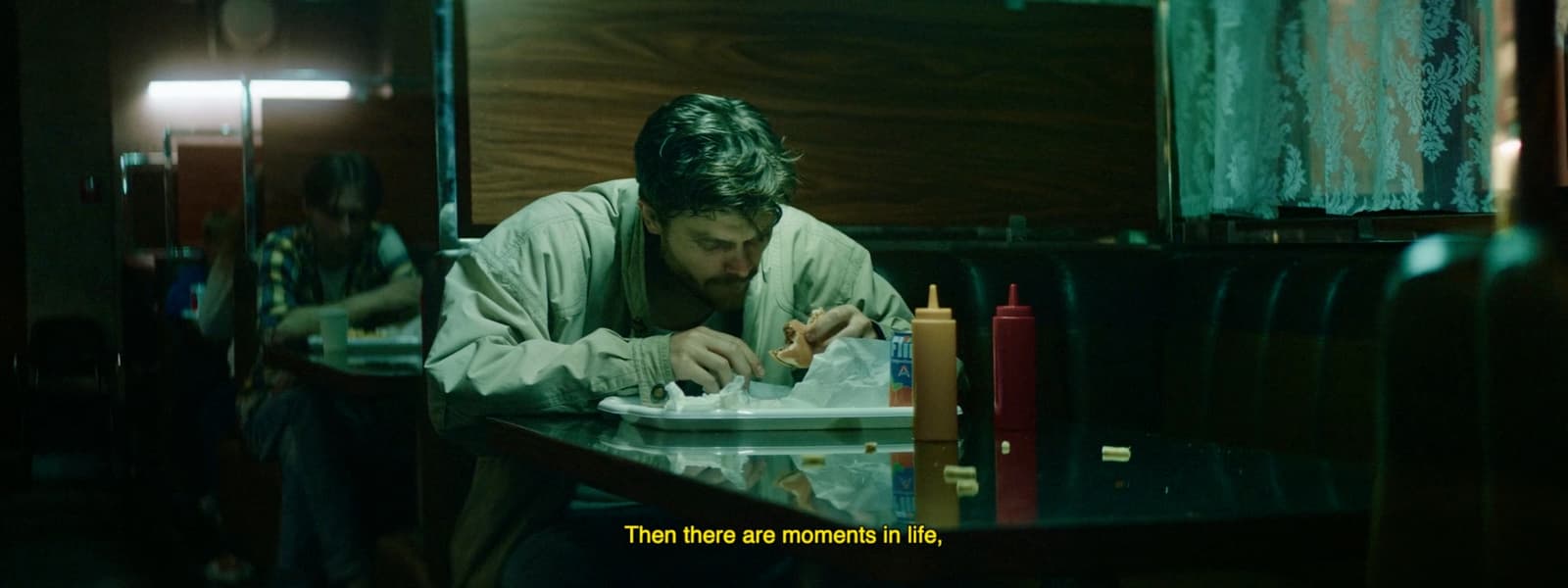 a man sitting at a table with a plate of food