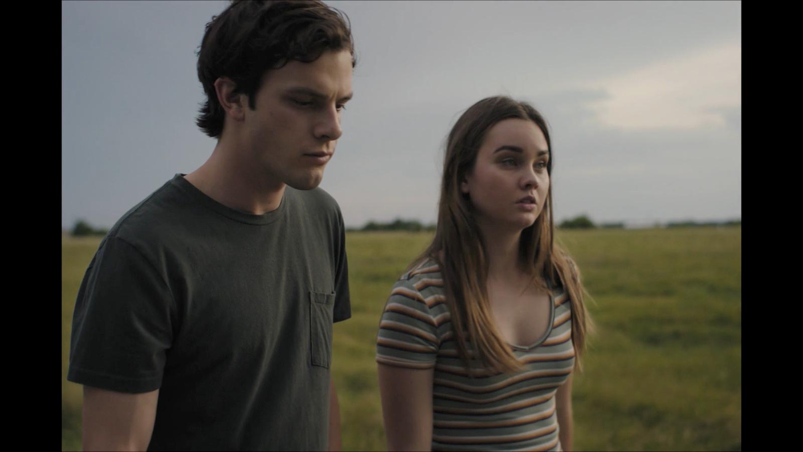 a man and a woman standing in a field