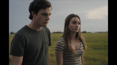 a man and a woman standing in a field