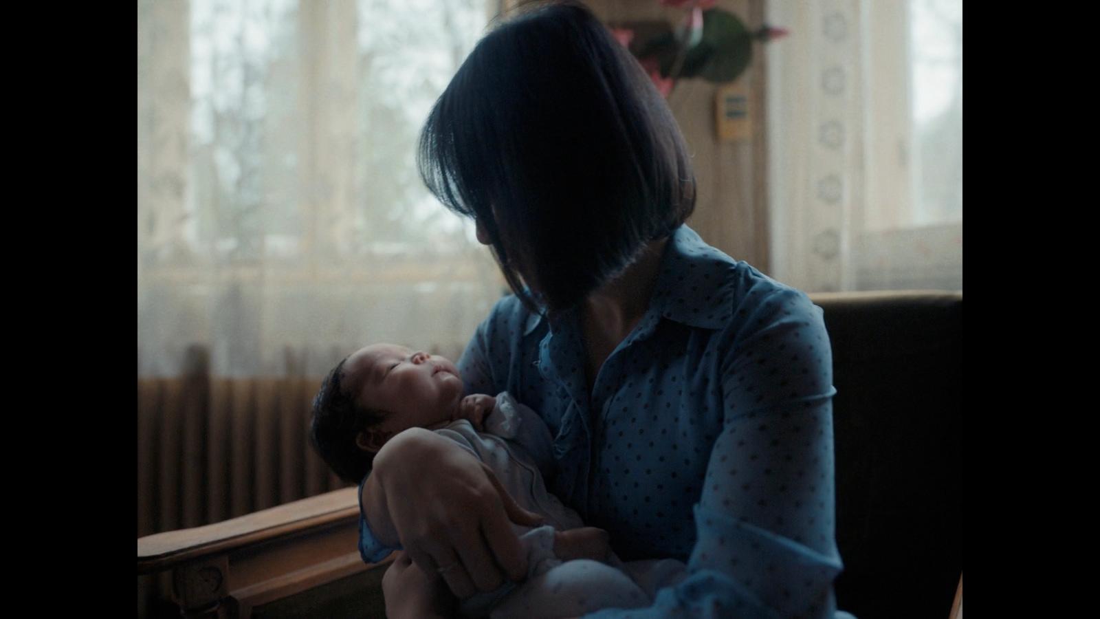a woman holding a baby in her arms