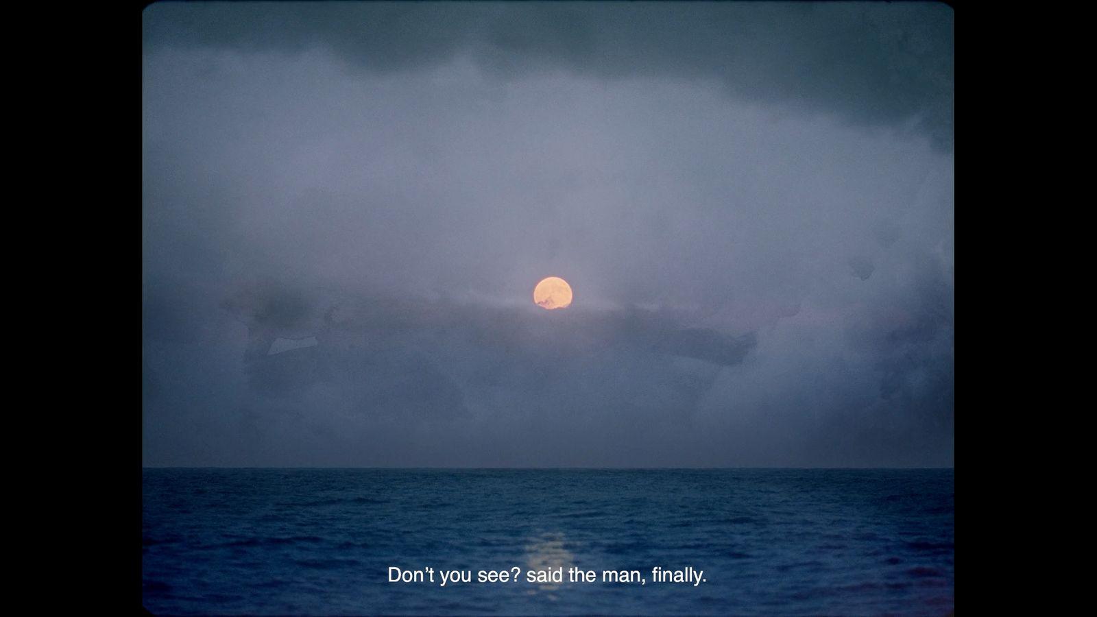 the sun is setting over the ocean on a cloudy day